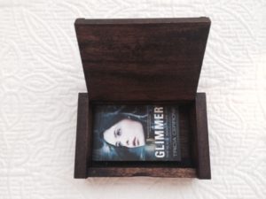 A business card holder from Thailand with cards from my latest book, GLIMMER.