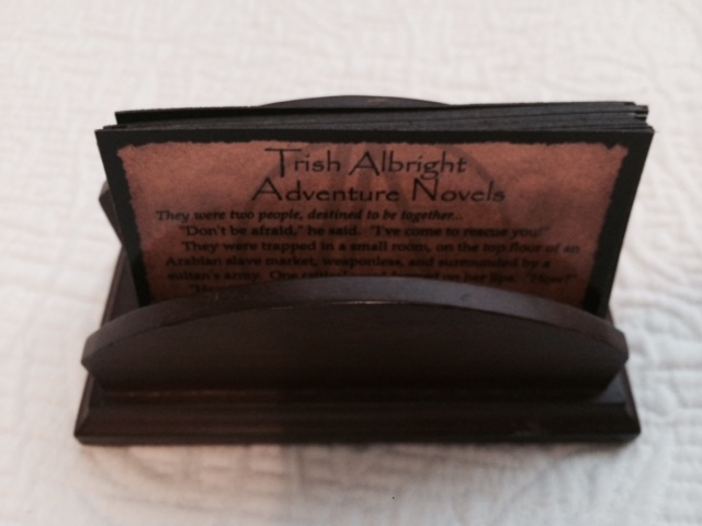 A simple, wood business card holder, perfect for cards about my adventure novels.